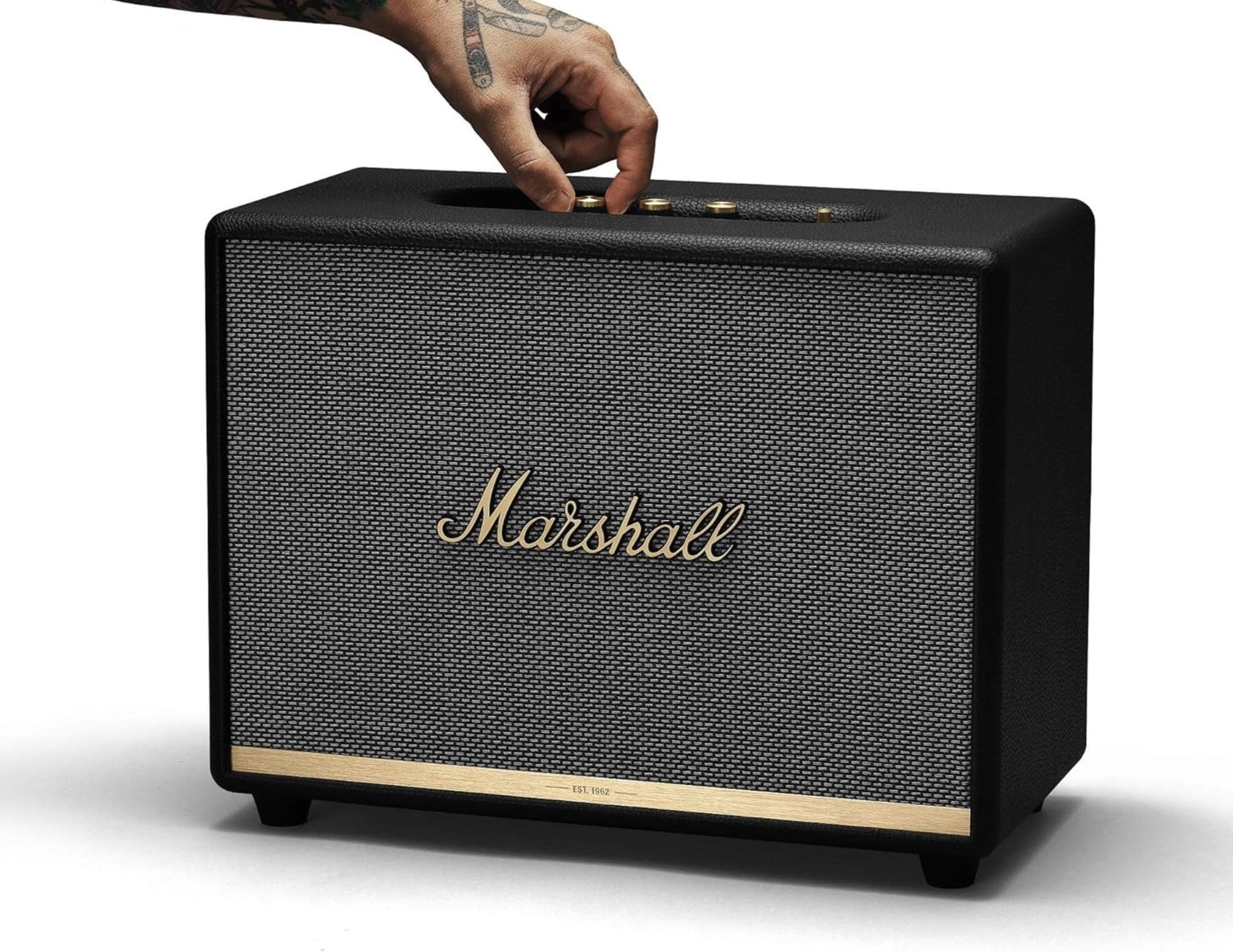 Marshall speaker with a hand pressing a button on a white background