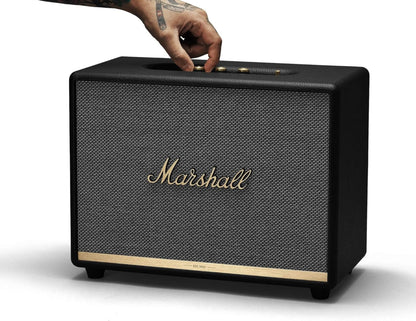Marshall speaker with a hand pressing a button on a white background
