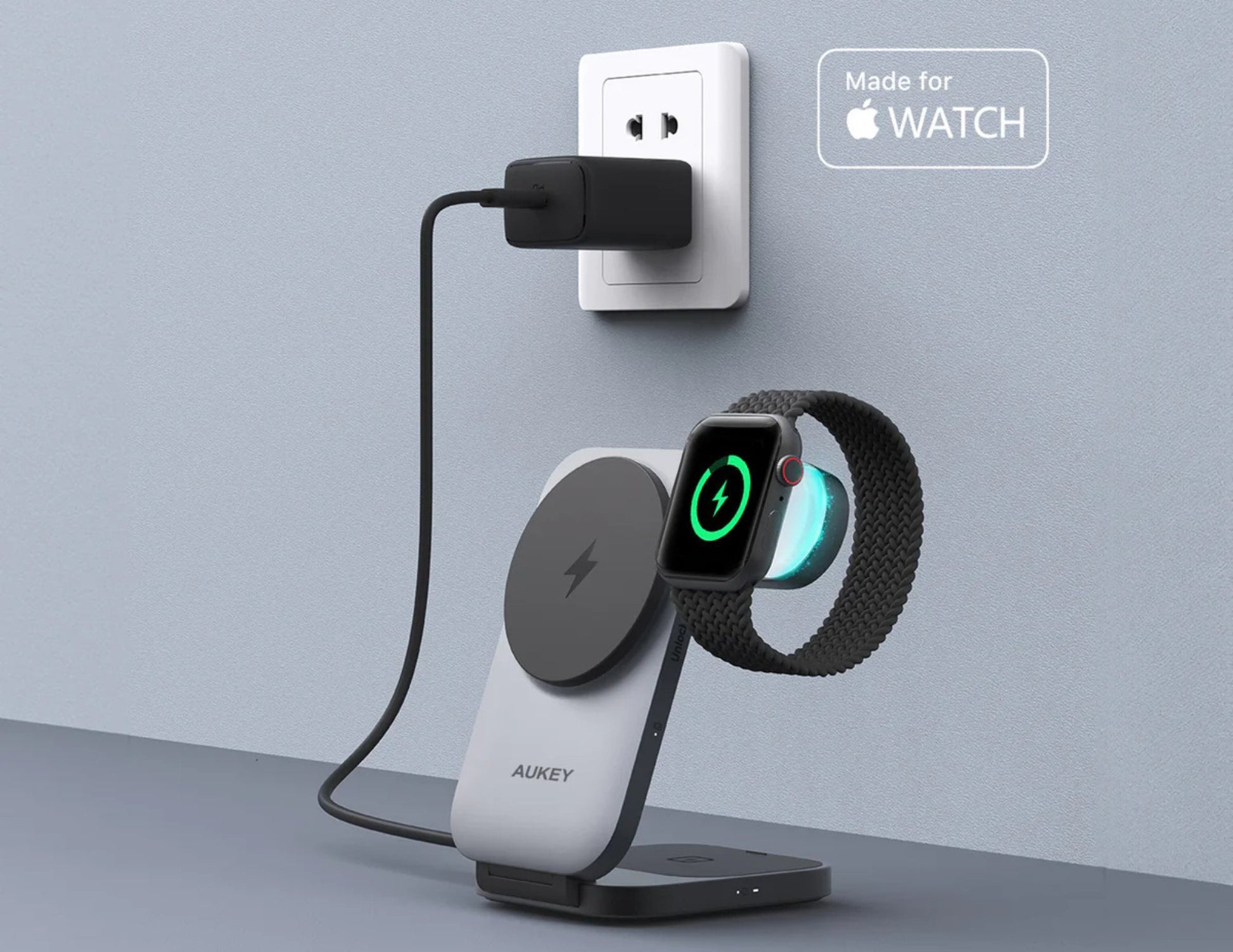 Aukey wireless charging stand with Apple Watch on a gray surface and light blue background