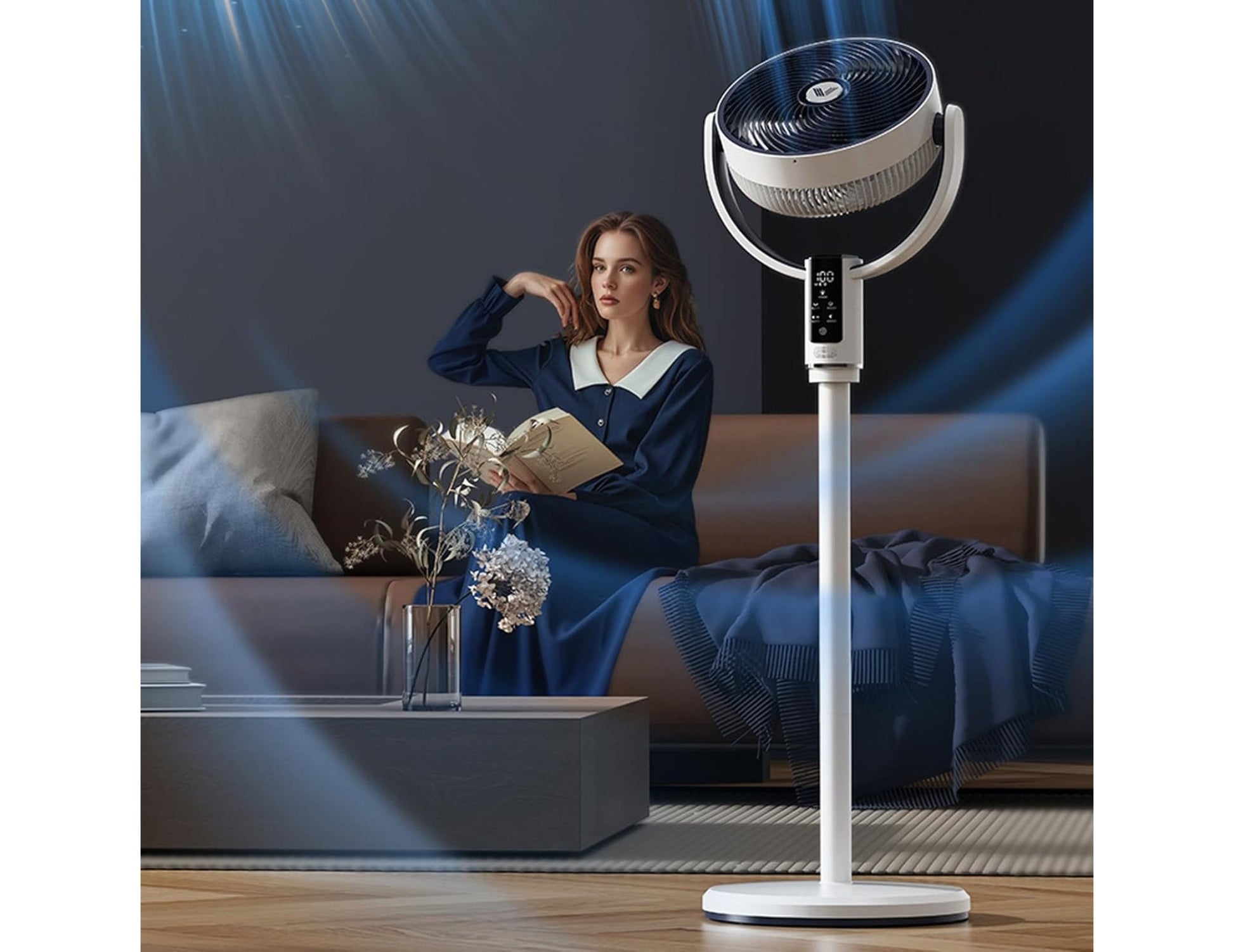 Woman sitting on a couch with a standing fan in a room