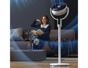 Woman sitting on a couch with a standing fan in a room