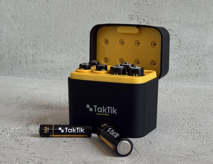 TakTik power bank with batteries on a gray surface
