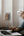 Person using a laptop with a power adapter on a wall socket in the background
