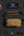 Collection of items including a Nintendo Switch console,Tomtoc Wander-T26 X-Pac Daily Sling Bag – Brown (T26S1K1), and various accessories on a dark surface.