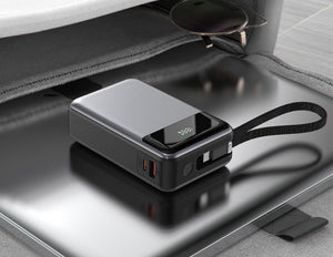 Acefast M21 20000mAh PD65W Power Bank with a strap on a metallic surface