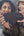 Two women holding a smartphone together, smiling.
