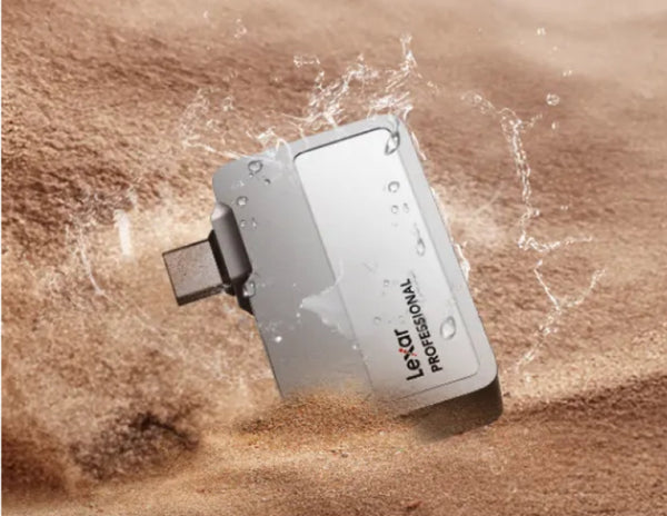 Lexar Professional USB drive being submerged in water on a sandy background