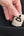 Momax 1‑World² 5‑Port Mini Universal Travel GaN Charger 70W with Dual AC – UA22L2 with '1-World' branding being placed into a black pocket.
