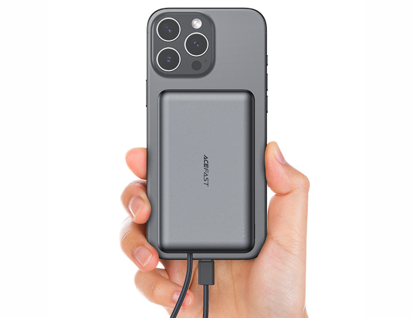 Hand holding a phone with a power bank attached on a white background