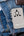 Gray Momax 1‑World+ 70W GaN 3‑Port Travel Adapter with Retractable USB‑C Cable – UA18 on a blue denim surface