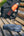 Blue Sony headphones on a wooden bench with a blurred background