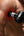Person using a Kica Evo Fascia Massage Gun on their shoulder against a black background