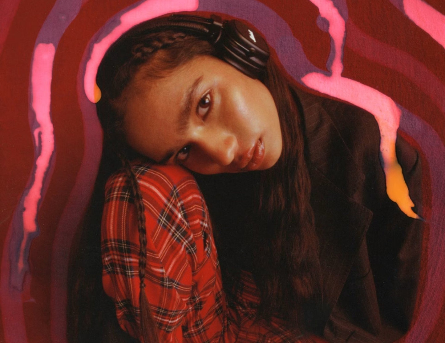 Person wearing headphones with a stylized pink and purple background