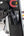 Black weightlifting bag attached to a weight rack with visible brand logos.