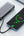 Phone being charged by a power bank on a white surface