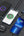 Multiple smartphones with charging icons on a dark surface