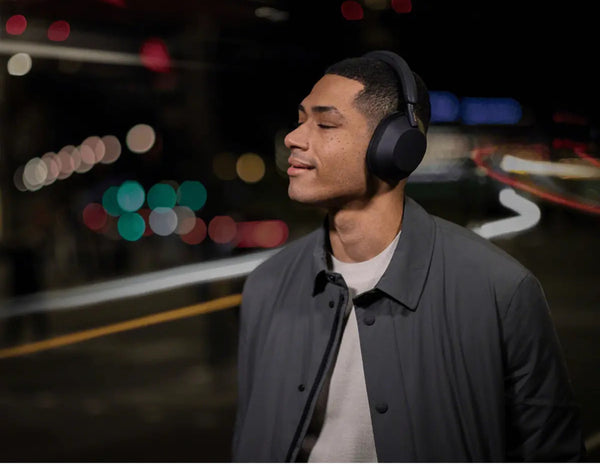 Man wearing headphones with a blurred colorful background