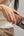 Person holding a phone with a Pitaka MagSafe Woven Wallet – Magsafe Compatible MWW240 against a neutral background