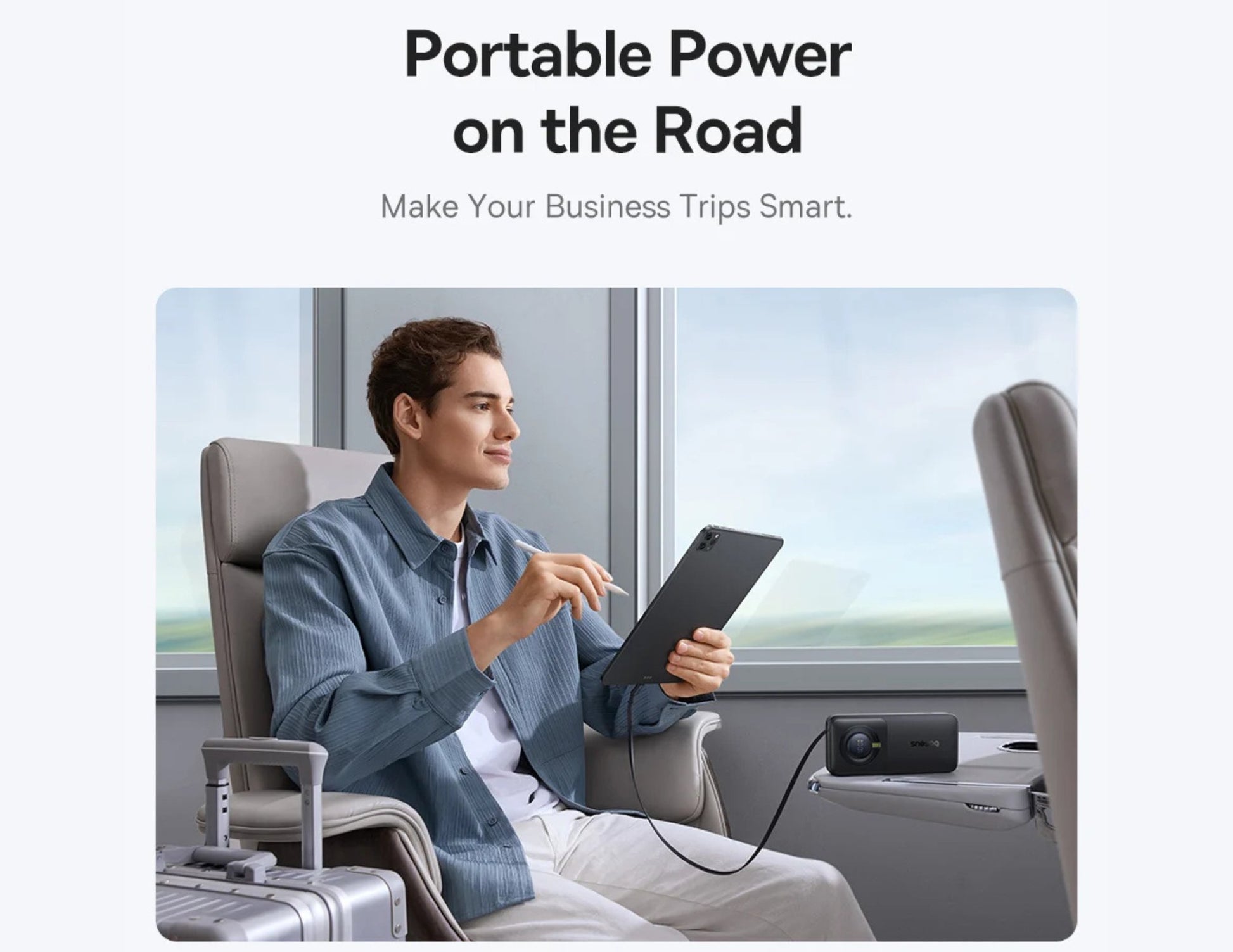 Man using a tablet on a train with text 'Portable Power on the Road' and 'Make Your Business Trips Smart'.