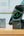 Smartphone with a charging stand on a wooden surface, with a blurred background.