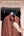 Brown jacket on a hanger with a hand using a Moxedo 2-in-1 Dynamic Steam Flat Iron MX-DF1011, text about wrinkle removal.