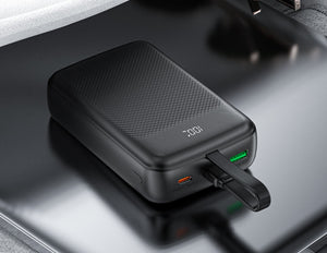 Black portable charger on a reflective surface