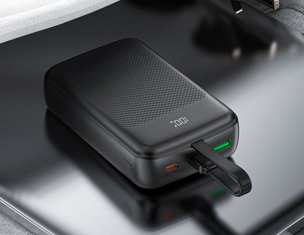 Black portable charger on a reflective surface