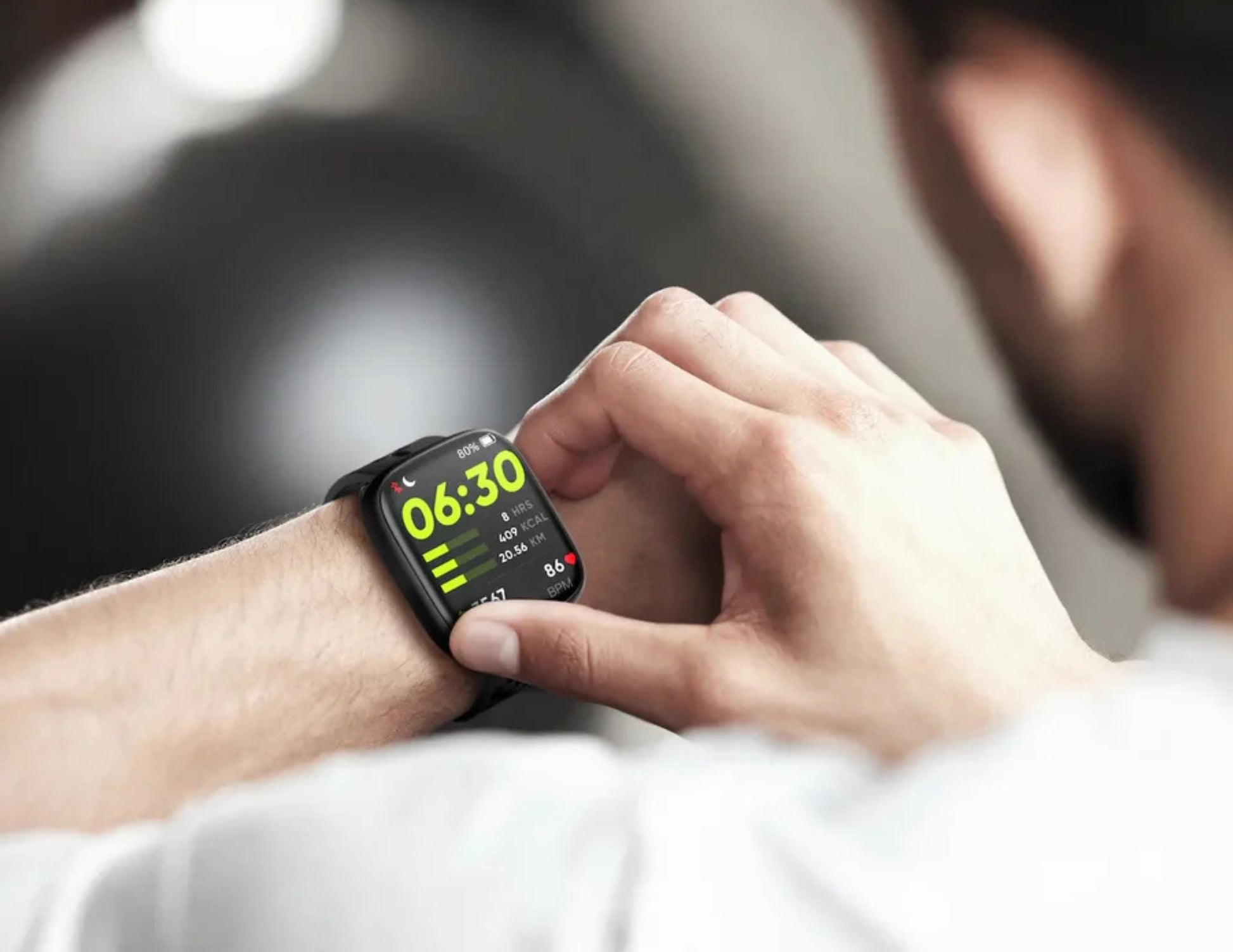 Person using a smartwatch with a blurred background