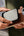 Person holding a phone with a case on, showing the brand 'UNIQ'.