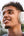 Man wearing white headphones with a blurred outdoor background