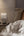 Woman in bed using a smartphone with a nightstand featuring electrical outlets and switches.
