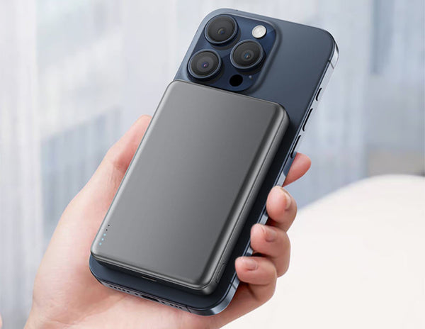 Person holding a smartphone with a Acefast M12 10000mAh Power Bank on a blurred background