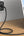 Wall charger with multiple ports connected to a laptop on a wooden surface.