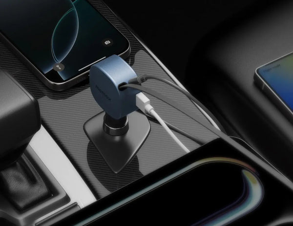 Car dashboard with a Momax 1-Move⁺ 2-Port Car Charger With Built-In Retractable Cable 60W (UC19E) and smartphone, featuring a charging cable.