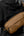 Person wearing a black jacket with a Tomtoc Wander-T26 X-Pac Daily Sling Bag – Brown (T26S1K1) on a gray background