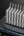 Row of electronic devices on a charging station with a dark background.