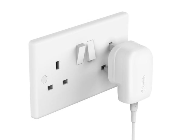 White wall socket with a Belkin BoostCharge Wall Charger 30W PPS + USB-C to USB-C Cable 1m – WCA005my1MWH-B6 attached on a white background