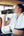 Woman in a gym drinking from a Tyeso TS-8828 Vacuum Insulated Tumbler 900ML with another person in the background.