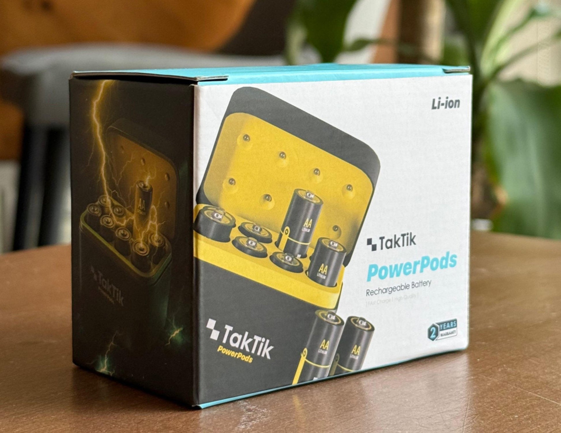 TakTik PowerPods packaging on a wooden surface with a blurred background