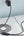 Black braided cable plugged into a laptop and wall outlet on a white surface.