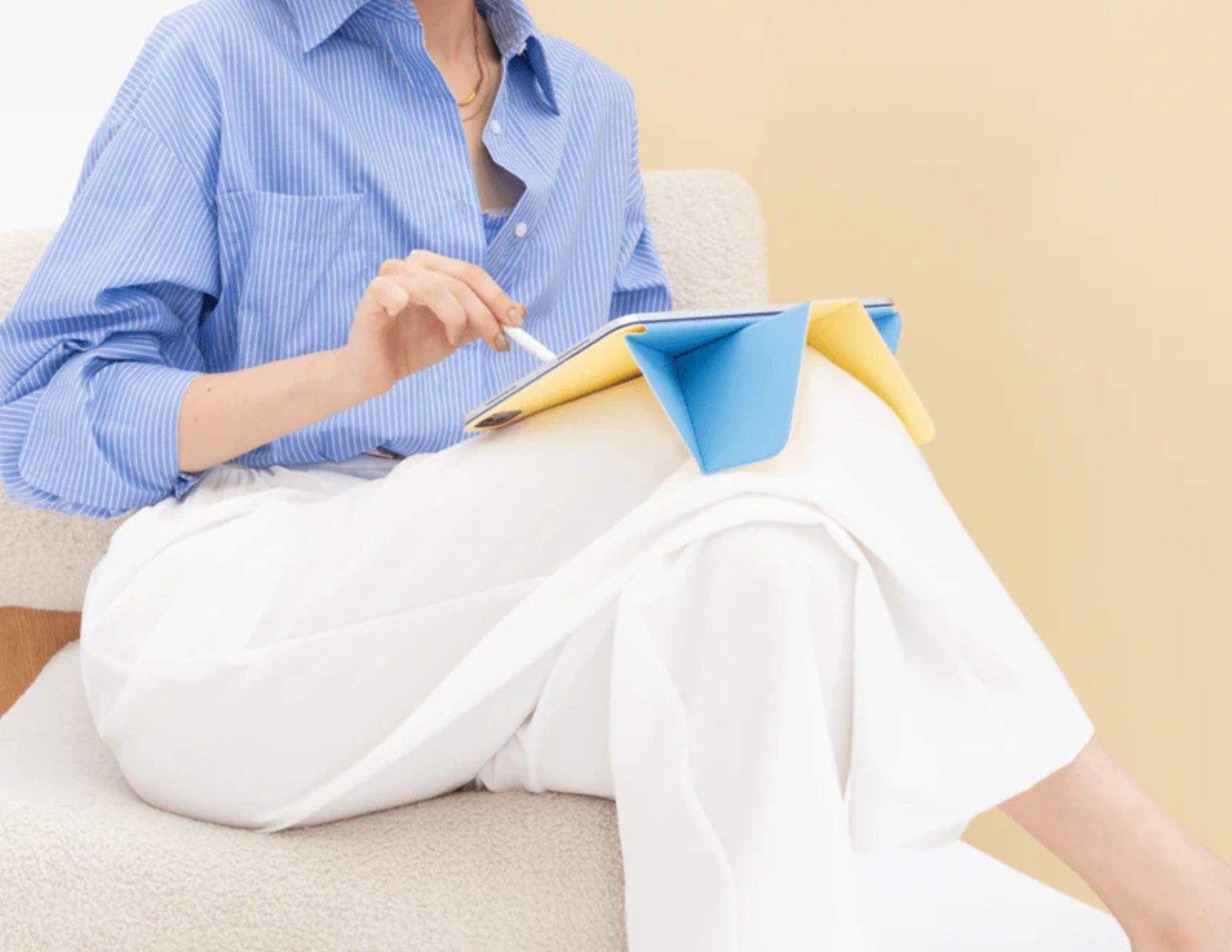 Person sitting on a couch holding a tablet with Moft Dynamic Folio Case for iPad Pro 13-inch (M4).