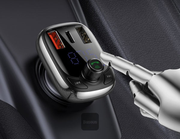 Car charger with Bluetooth speaker and digital display on a car dashboard.