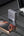 Maxedo external desktop charger connected to a smartphone on a desk with a laptop in the background