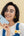 Woman holding a phone with a light blue case against a beige background