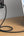 Laptop connected to a power adapter on a wooden surface with a blurred background