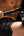 Person using a Kica Evo Fascia Massage Gun on their leg against a black background