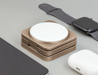 Wireless charging pad with Apple Watch and AirPods on a light gray surface