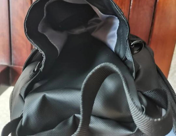 Gray backpack with a wooden surface background