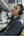 Man wearing headphones and looking out a window in a train station