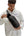 Person wearing a white hoodie with text holding a Tomtoc GameOn-G49 Nintendo Switch 2 Sling Bag – Black (G49S1D1) on a white background